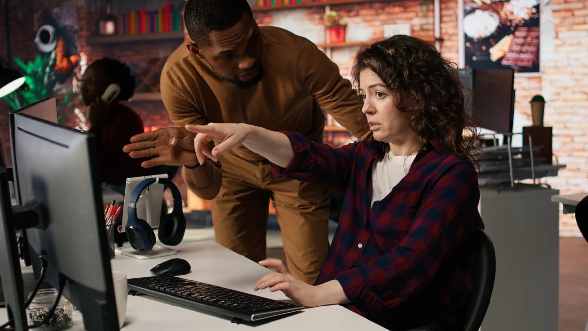 Startup office supervisor checking up on IT expert using artificial intelligence