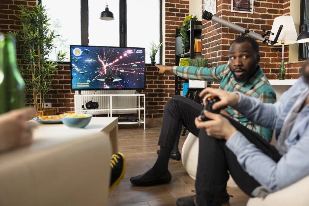 Diverse men bonding through video games at home