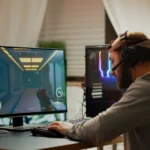 Cyber sport gamer wearing headphones playing first person shooter videogame