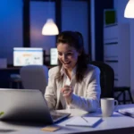Business woman looking at professional laptop working at marketing graphs project